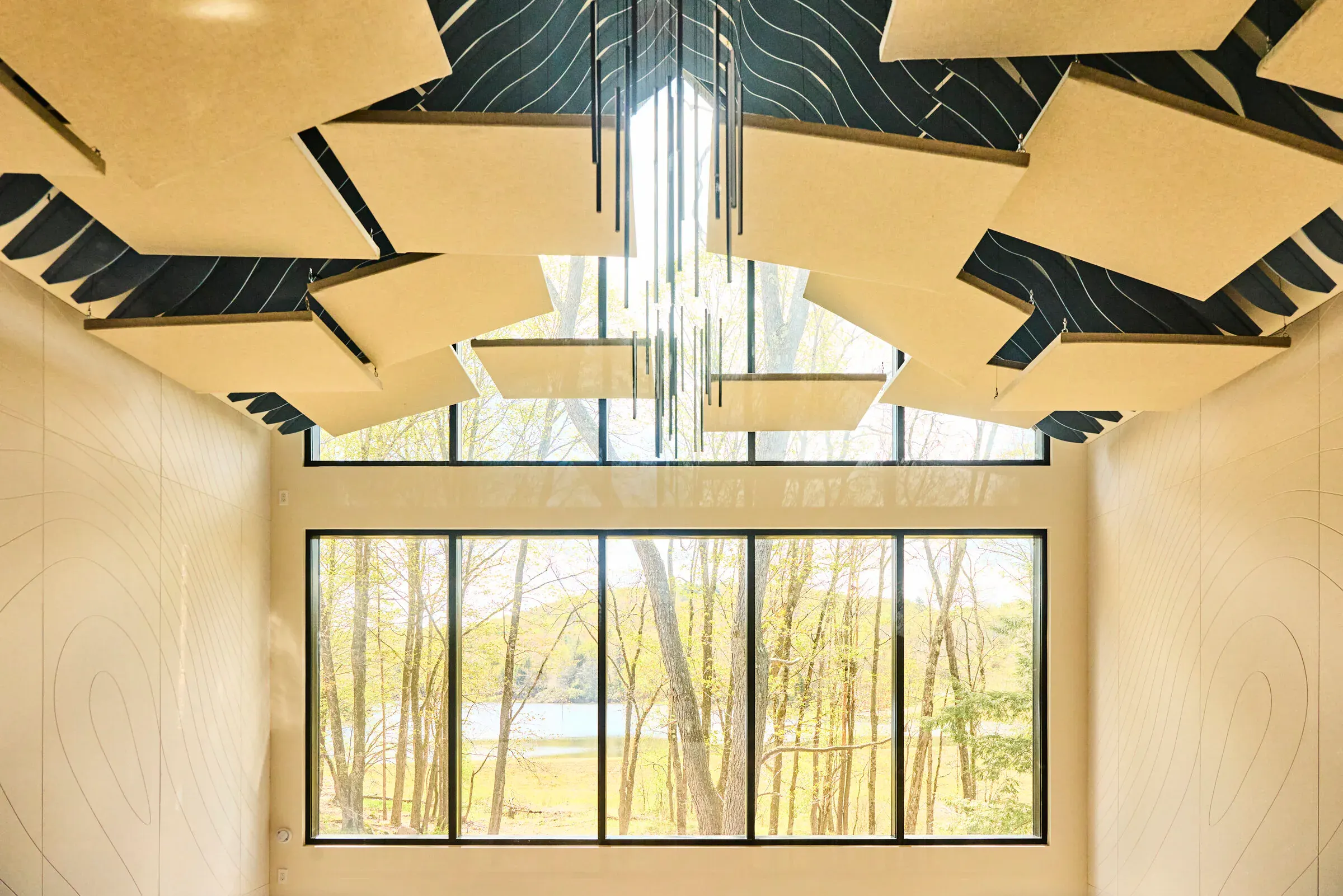 Acoustic ceiling panels in the Verdant Sound live room with a view of the lake through upper windows