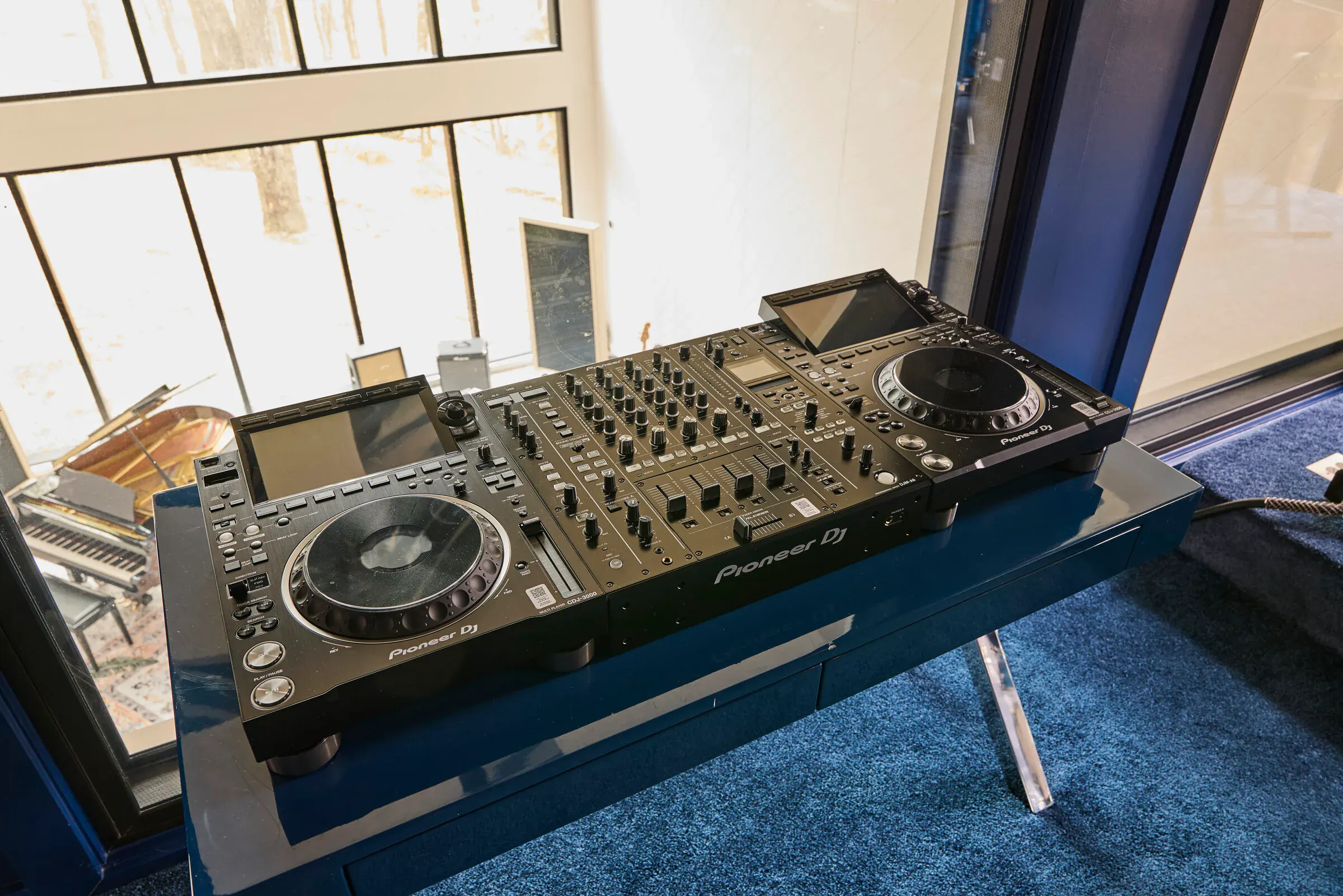 Pioneer DJ setup at Verdant Sound — CDJ-3000 media players and DJM-A9 mixer on a glass console